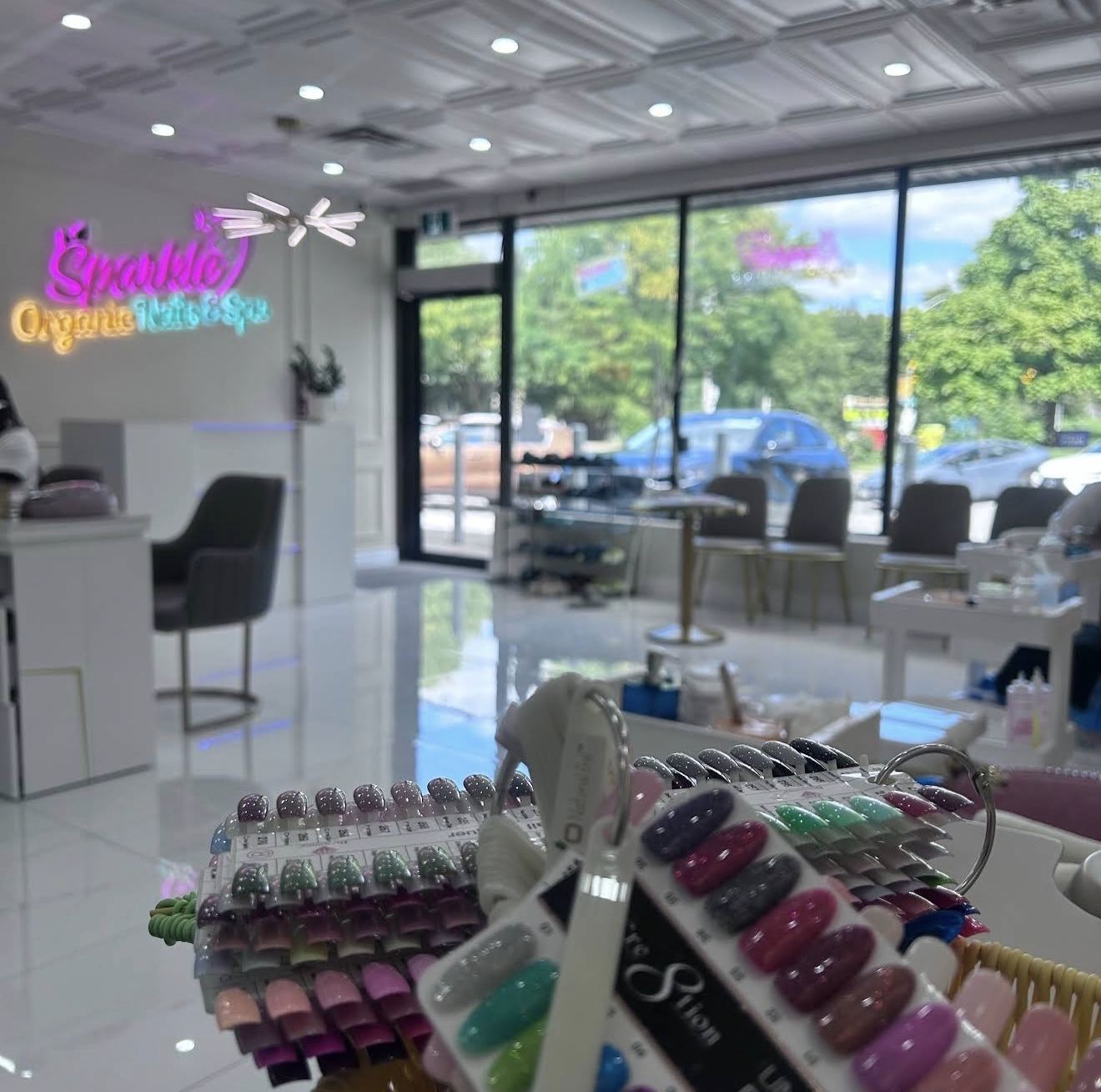 Nail colour swatches with the sparkle salon interior in the background.