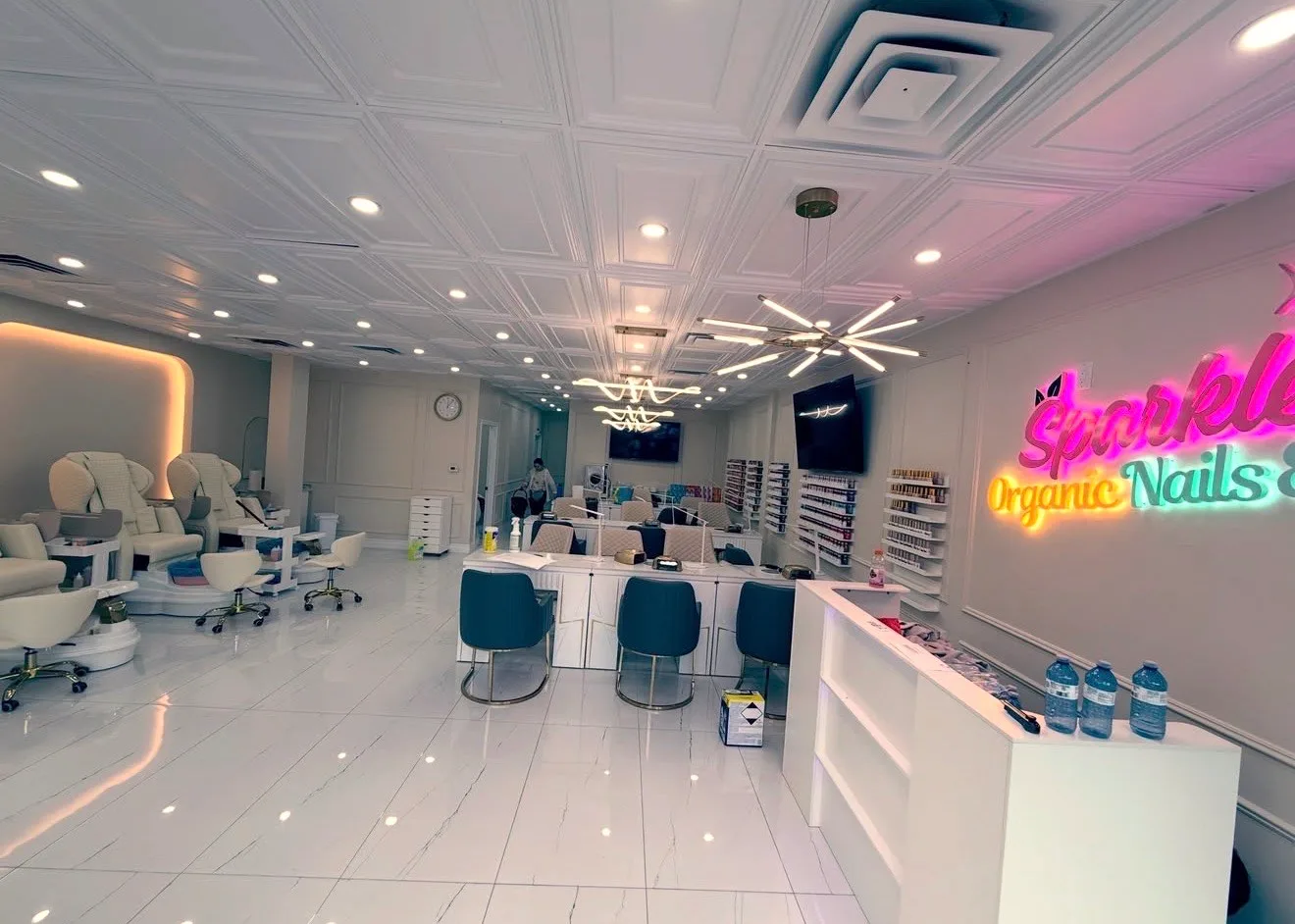 Reception, manicure tables and pedicure chairs inside sparkle organic nails & spa in london, ontario